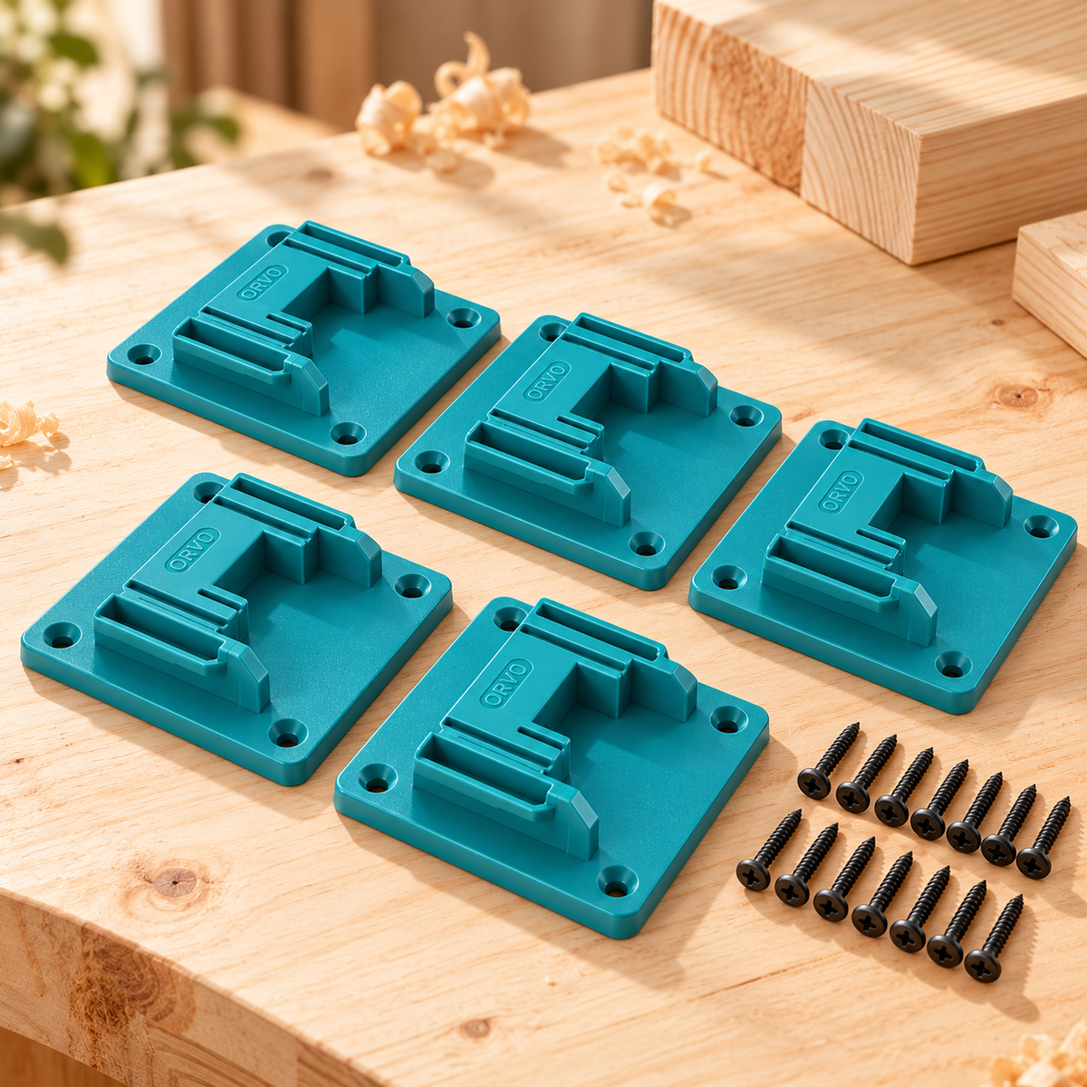 A turquoise tool holder being screwed to a wooden wall with a cordless drill
