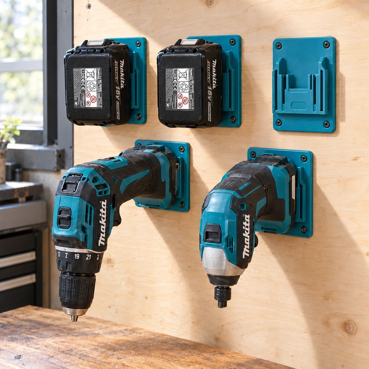 Five turquoise tool holders, each with four mounting holes, on a wooden workbench