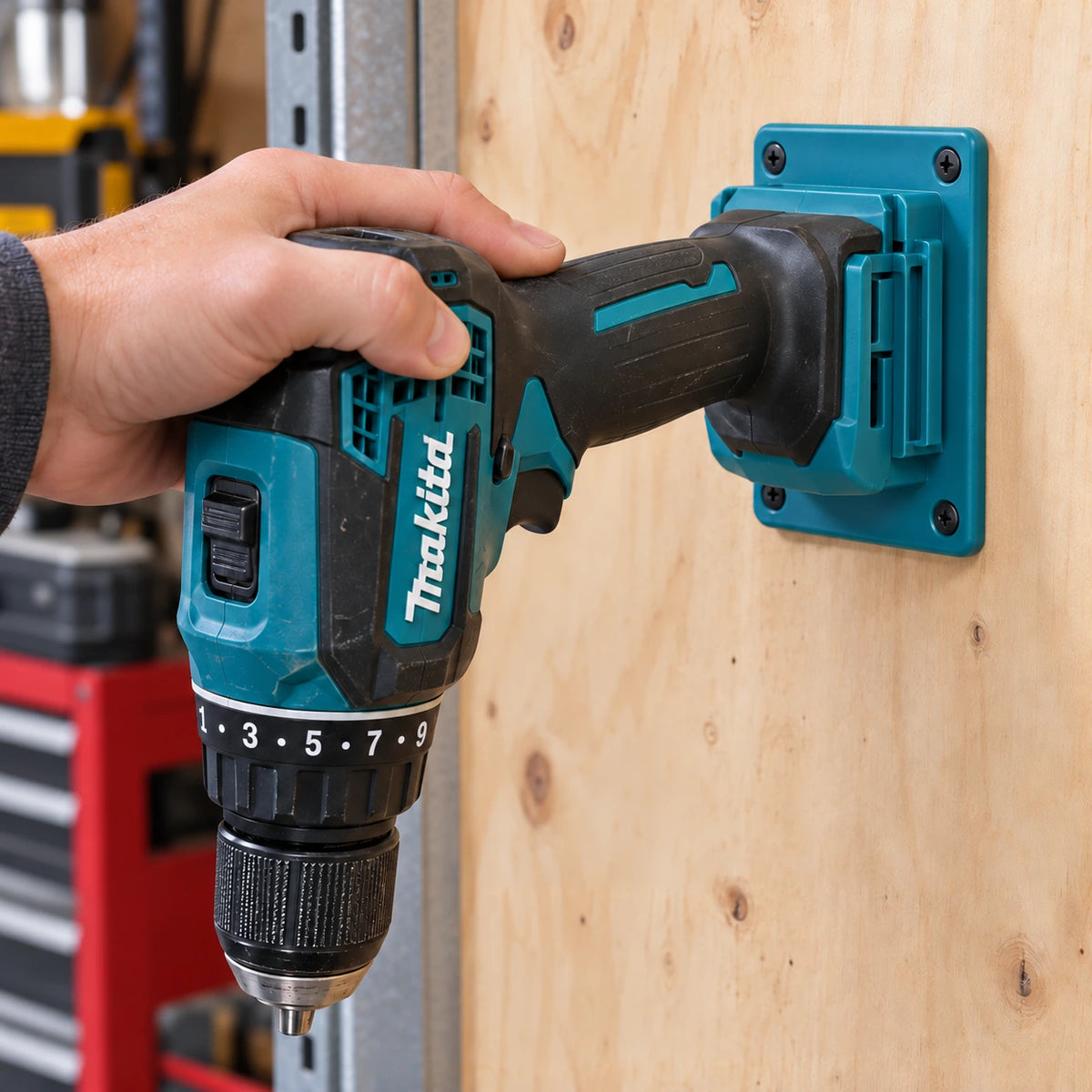 A hand slides a Makita drill driver into a turquoise holder by its battery slot